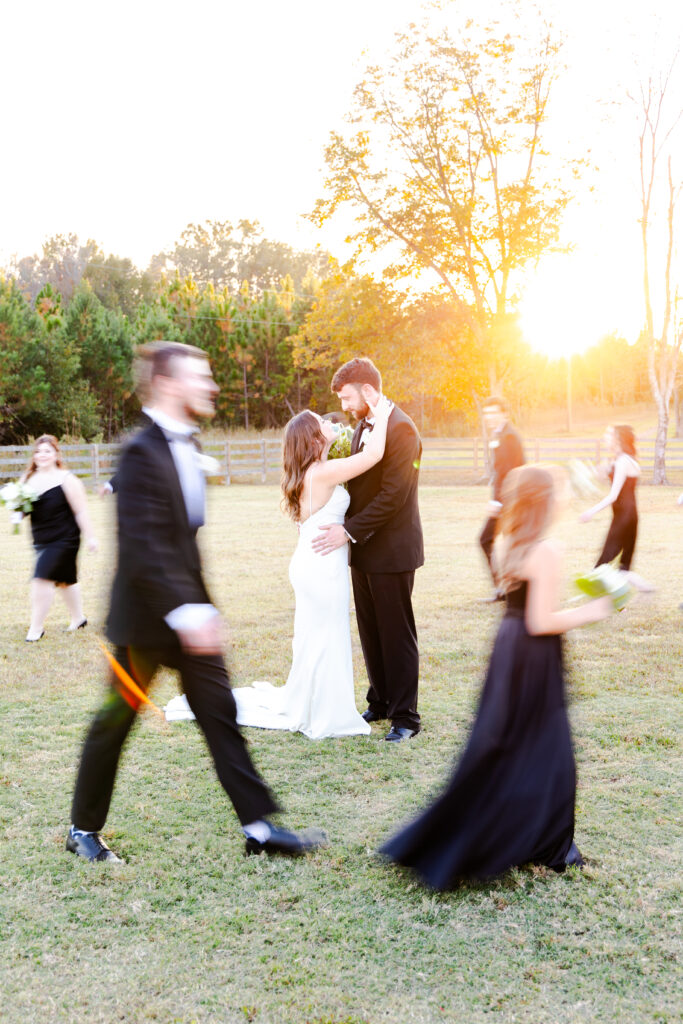 blurry wedding party with bride and groom in focus