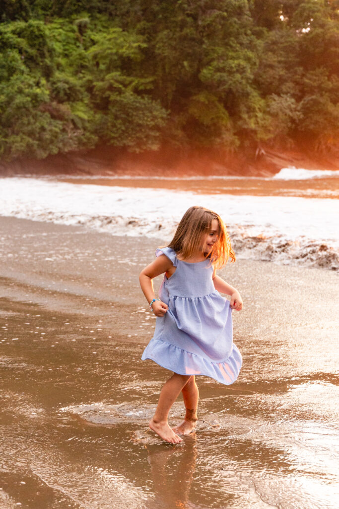 child dancing on the beach of costa rica