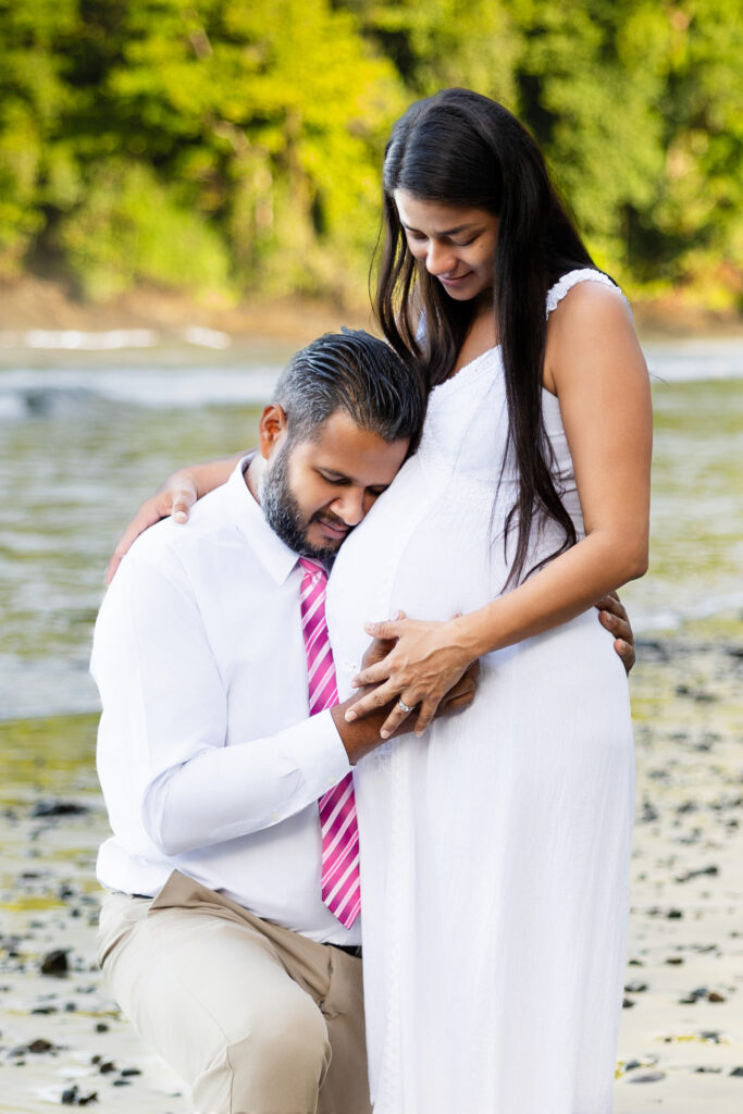 Man holds pregnant belly