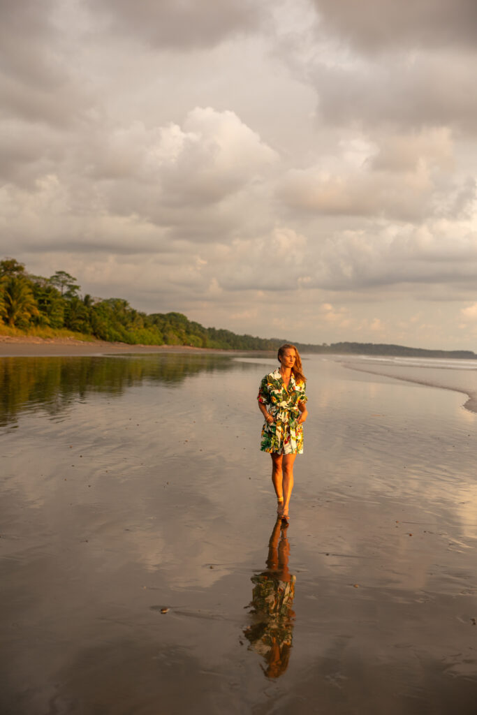 beautiful woman walking on the beach at sunset
