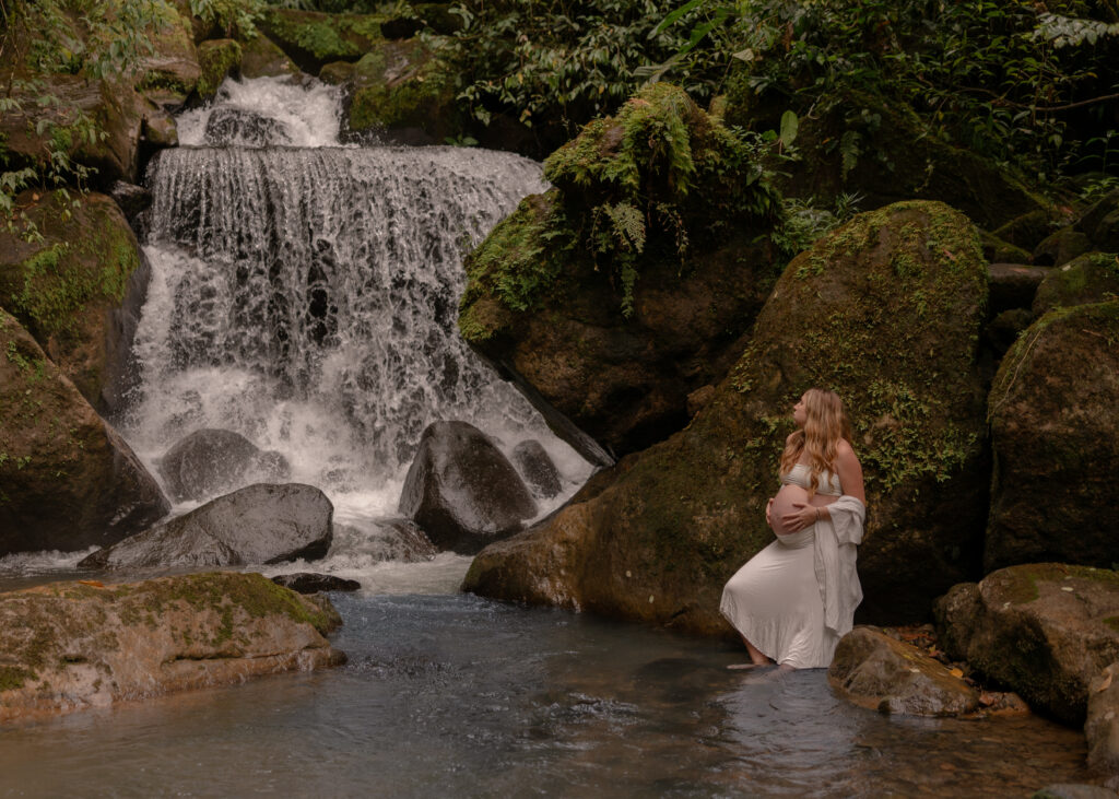 maternity in nature at a waterfall
