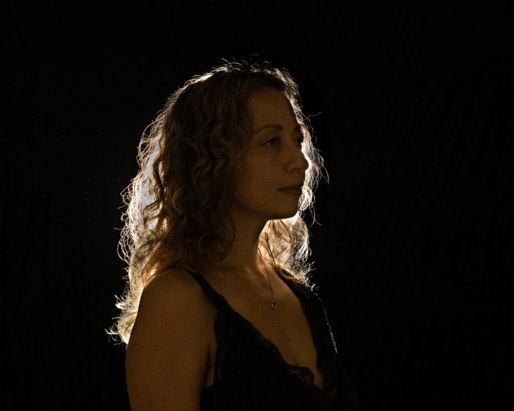 Creative Personal Branding Photography Silhouette of a woman with a black backdrop backlit for a halo effect