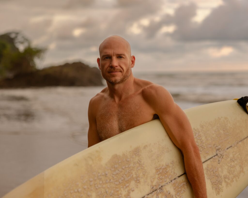 lifestyle personal branding photography of a surfer on the beach at sunset