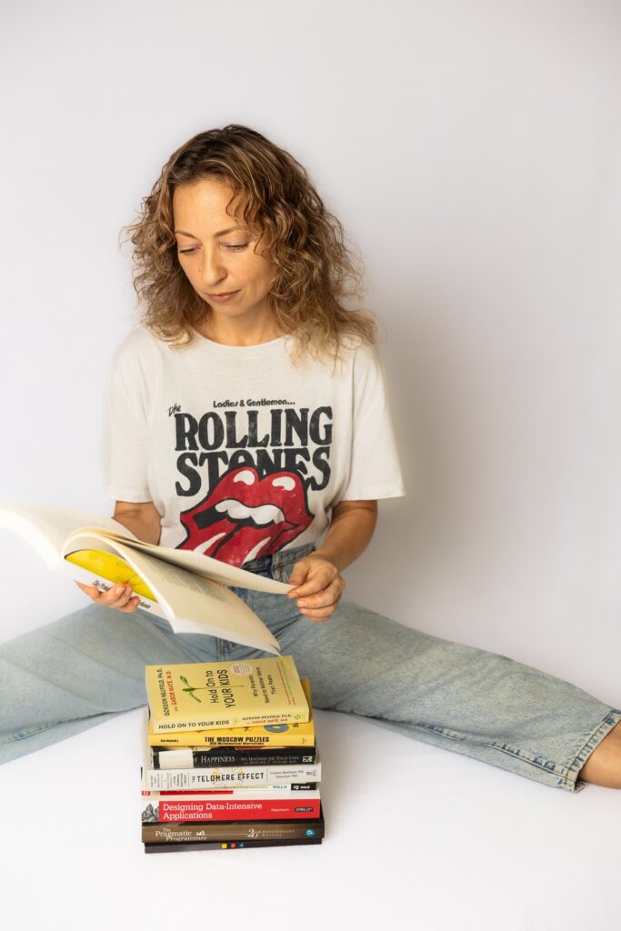 Creative Personal Branding Photography Ideas woman with a stack of books and a white backdrop